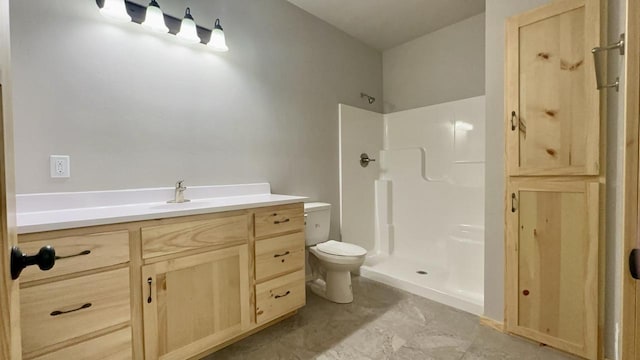 bathroom with vanity, toilet, and walk in shower