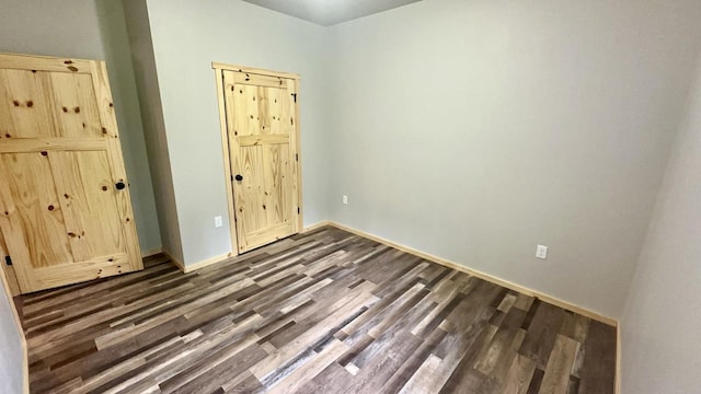 unfurnished bedroom featuring dark wood-type flooring