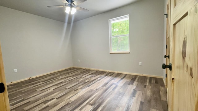 unfurnished room with ceiling fan and dark hardwood / wood-style floors