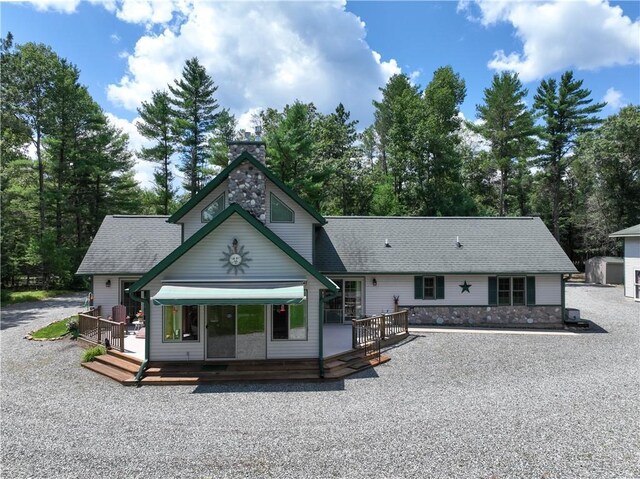 front of property with a carport, central AC, and a front yard