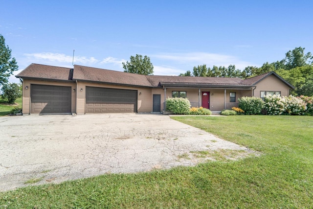 ranch-style home featuring a garage and a front yard