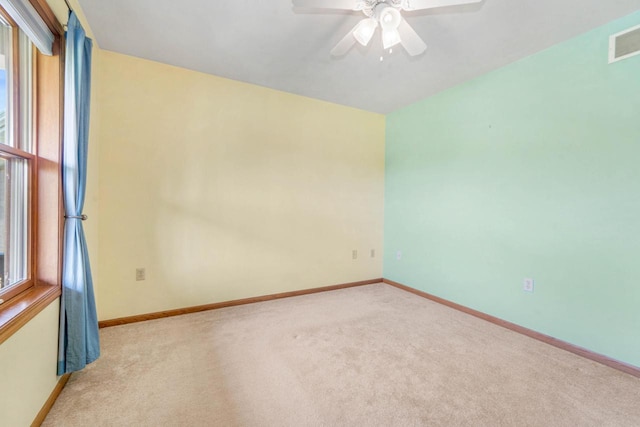 unfurnished room with ceiling fan and light colored carpet