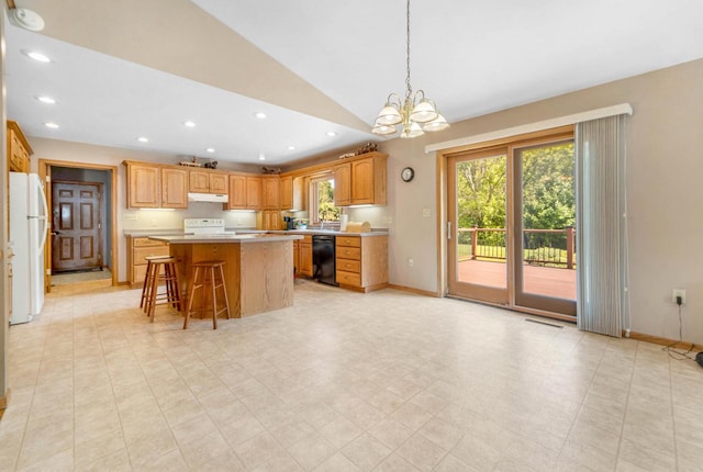 kitchen featuring a chandelier, light tile patterned floors, white appliances, and a kitchen island