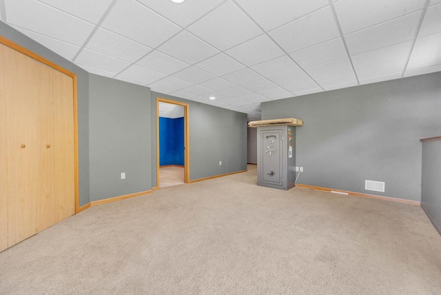 basement featuring a drop ceiling and carpet floors