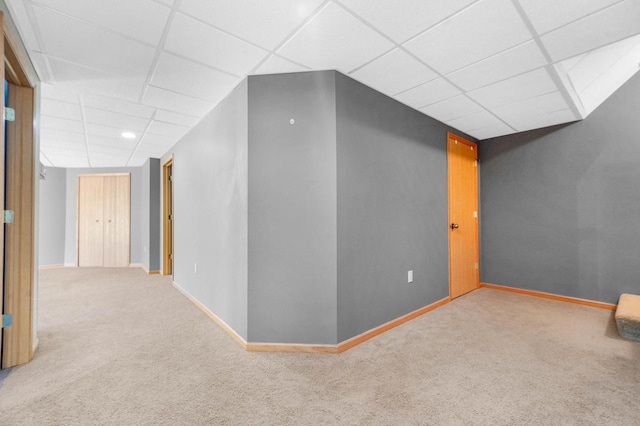 interior space featuring carpet floors and a paneled ceiling