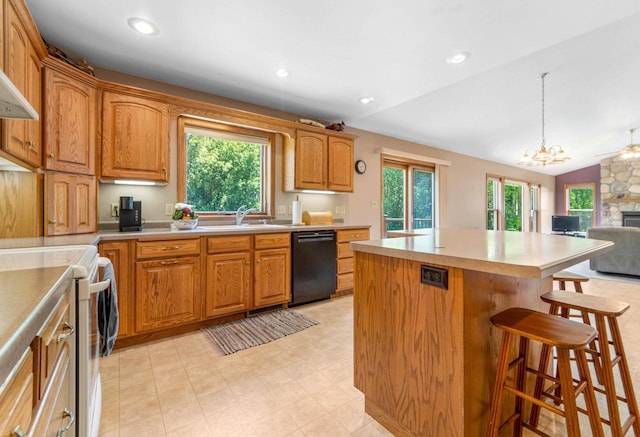 kitchen featuring white electric range, sink, dishwasher, a kitchen island, and pendant lighting