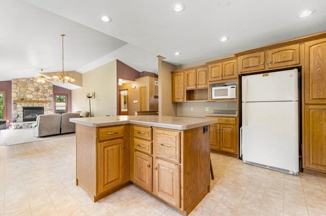 kitchen with white appliances, decorative light fixtures, vaulted ceiling, and a kitchen island