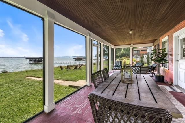 sunroom featuring plenty of natural light, wooden ceiling, and a water view