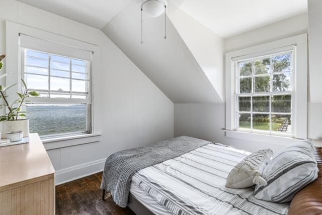 bedroom with vaulted ceiling and dark hardwood / wood-style floors