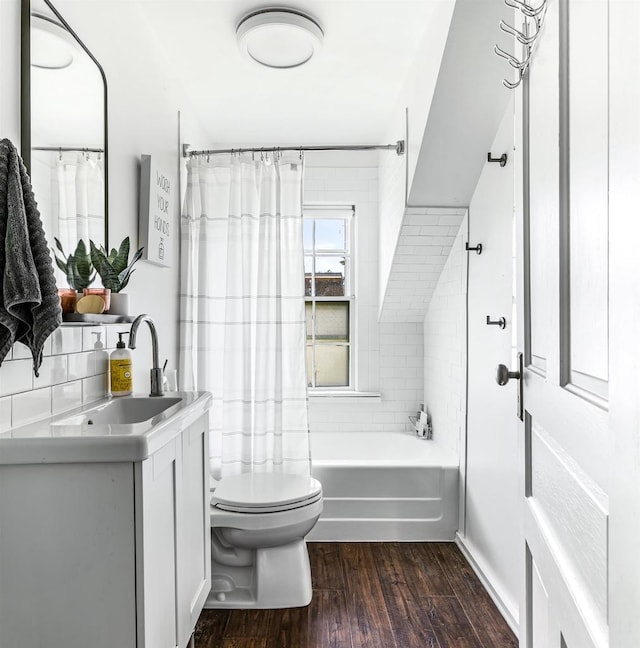 full bathroom with toilet, hardwood / wood-style flooring, shower / bath combo, and vanity