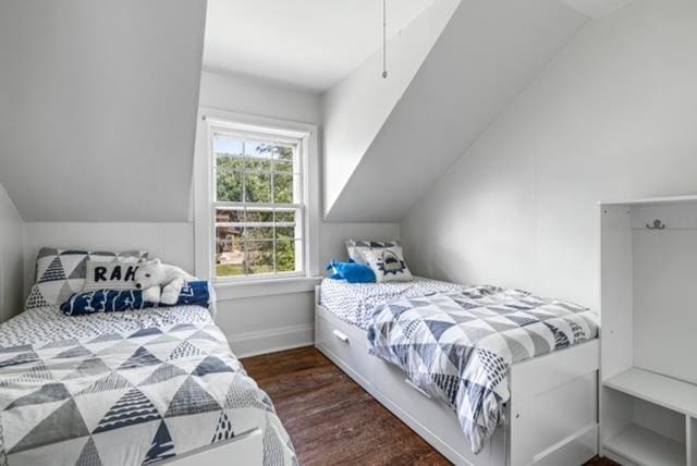 bedroom featuring vaulted ceiling and dark hardwood / wood-style floors