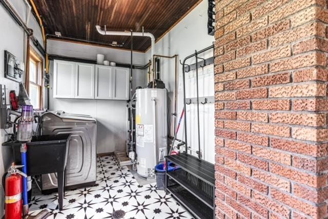 utility room featuring washer and dryer and water heater