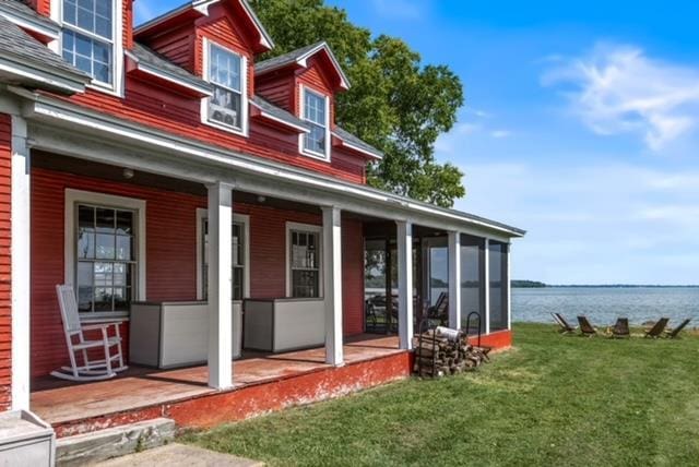 exterior space with a water view and a yard