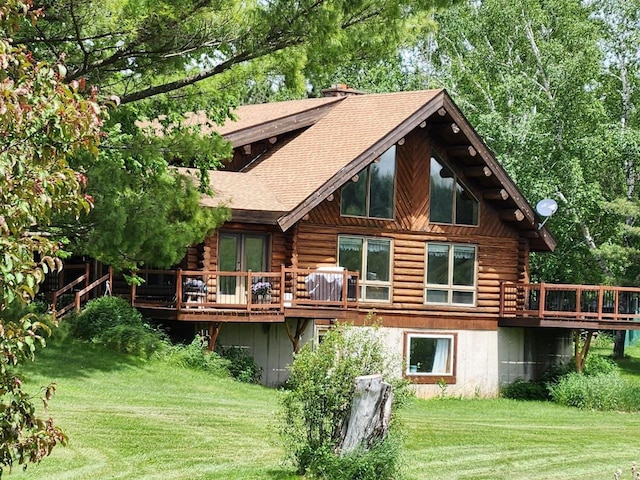 W6769 County Road D, Sheldon, WI 54766 - rear view of property featuring log exterior, a wooden deck, and a yard