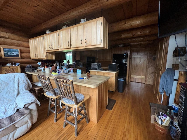 W6769 County Road D, Sheldon, WI 54766 - kitchen with wooden ceiling with exposed beams, light countertops, rustic walls, a peninsula, and light wood-style flooring