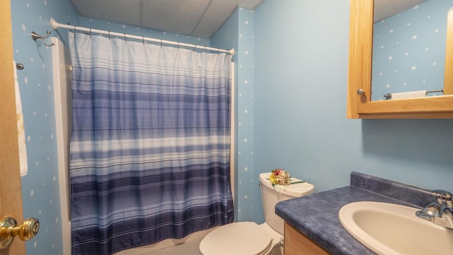 bathroom featuring a textured ceiling, vanity, and toilet