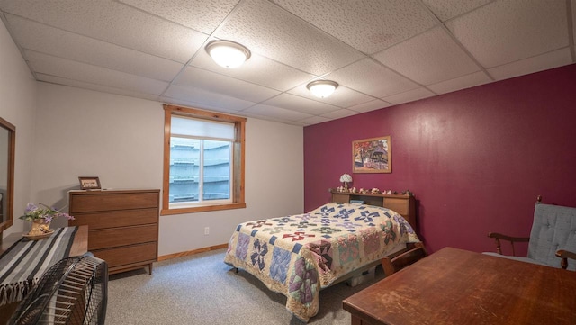 carpeted bedroom featuring a paneled ceiling