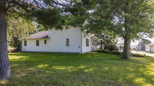 view of side of property featuring a yard