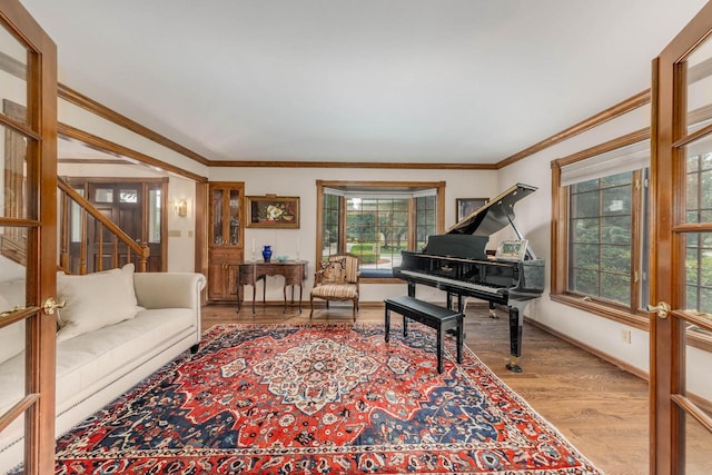 living area featuring crown molding, french doors, and light wood-type flooring