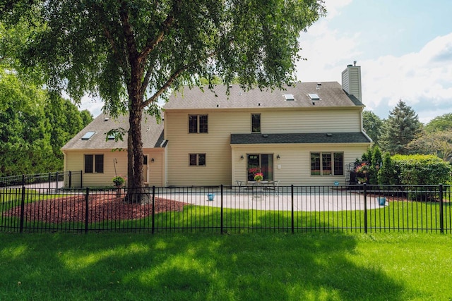 back of property with a lawn and a fenced in pool