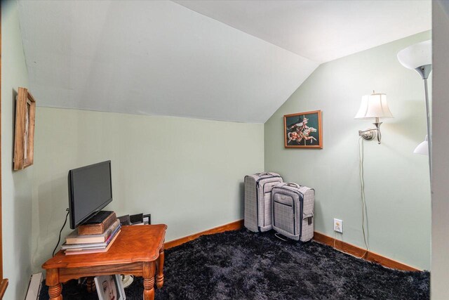 home office with vaulted ceiling and carpet flooring