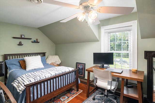 bedroom with lofted ceiling and wood-type flooring