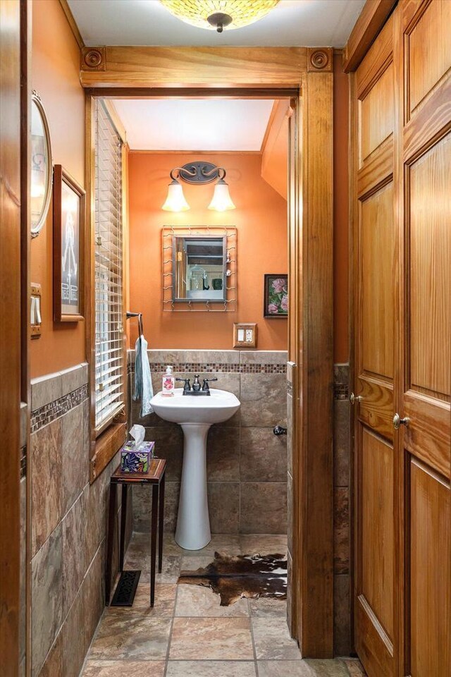 bathroom with tile walls