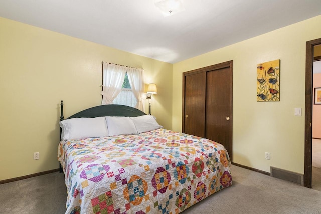 bedroom featuring light carpet and a closet