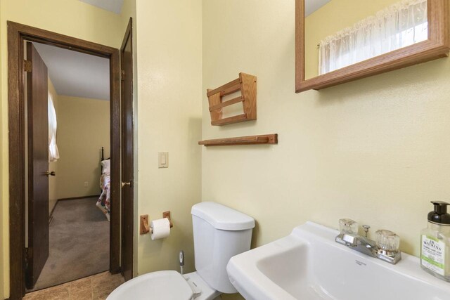 bathroom featuring sink and toilet