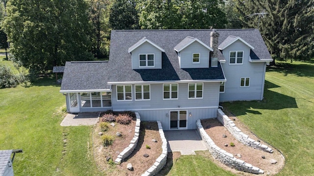 view of front of house with a patio and a front lawn