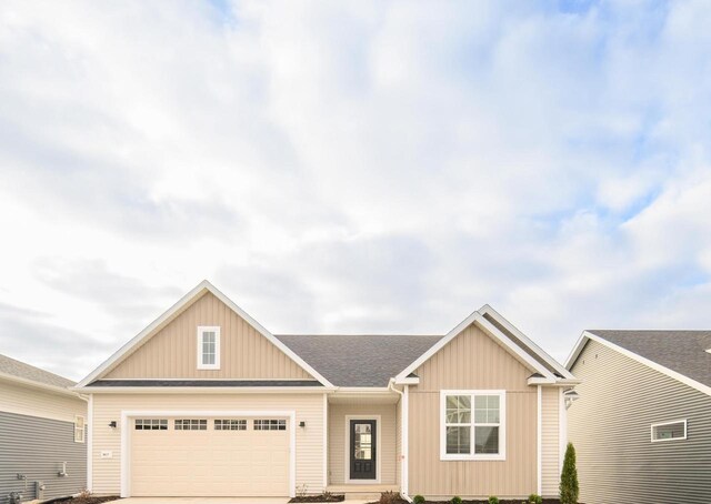 view of front of home with a front lawn and a garage