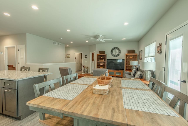 dining space featuring ceiling fan and light hardwood / wood-style flooring