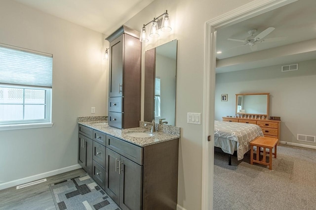 bathroom featuring ceiling fan and vanity