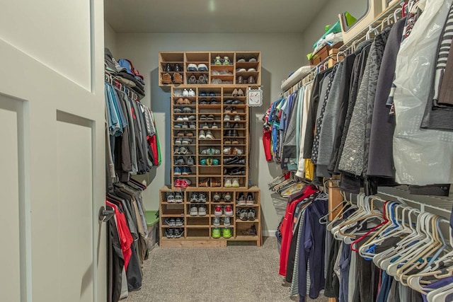 walk in closet featuring carpet