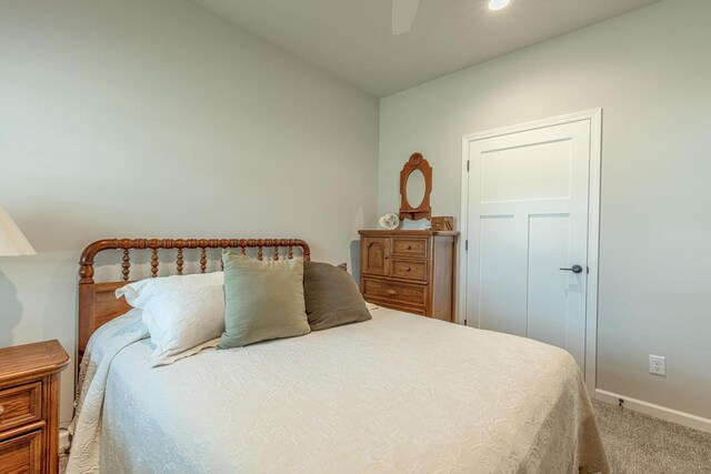 carpeted bedroom featuring ceiling fan