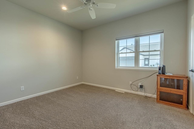 empty room featuring ceiling fan and carpet floors