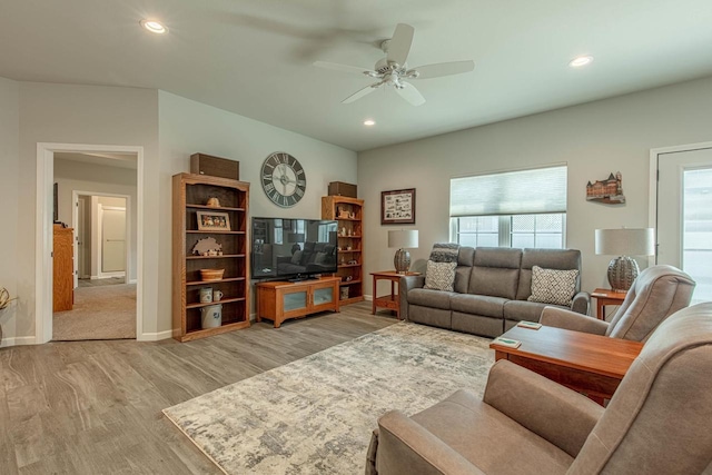 living room featuring light wood-type flooring and ceiling fan