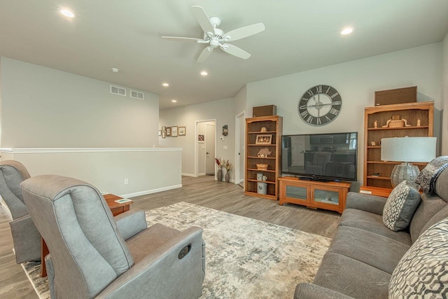 living room featuring ceiling fan and light hardwood / wood-style flooring