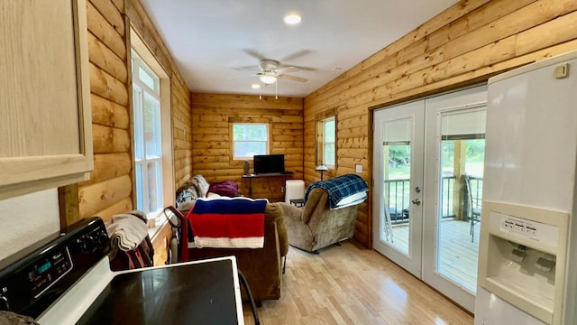 interior space with a wealth of natural light, ceiling fan, and french doors