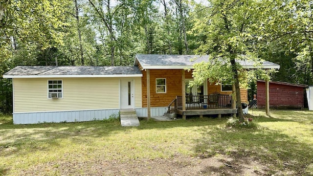 rear view of property featuring a lawn