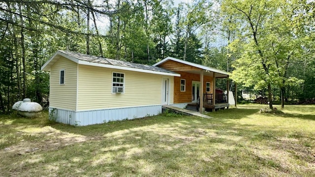 back of house with a lawn