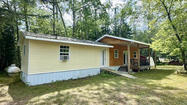 back of house with a lawn