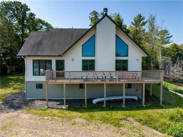 back of house with a lawn and a deck