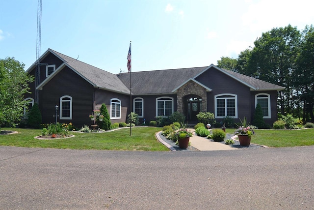 ranch-style home featuring a front yard