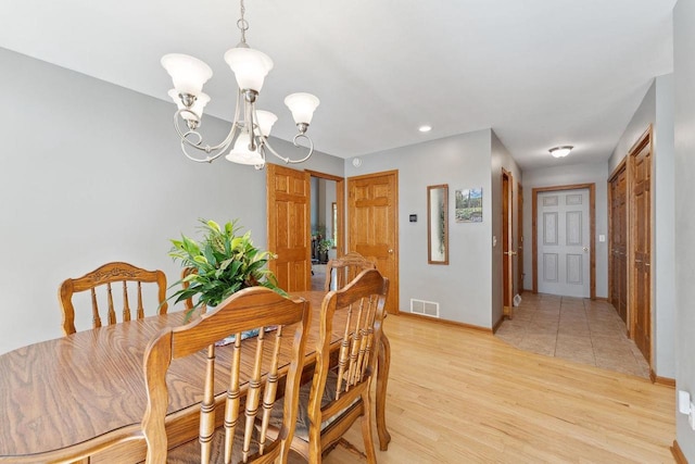 S2916A Fairway Dr, Reedsburg, WI 53959 - dining space featuring an inviting chandelier and light hardwood / wood-style flooring