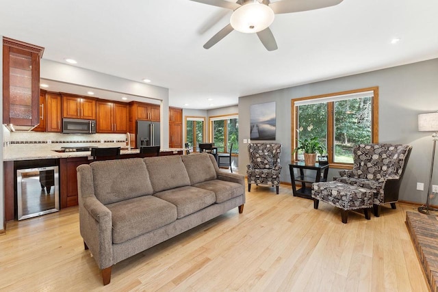 S2916A Fairway Dr, Reedsburg, WI 53959 - living room with ceiling fan, plenty of natural light, light wood-type flooring, and wine cooler