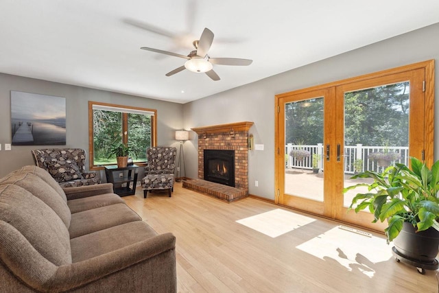 S2916A Fairway Dr, Reedsburg, WI 53959 - living room with a brick fireplace, light wood-type flooring, french doors, and ceiling fan