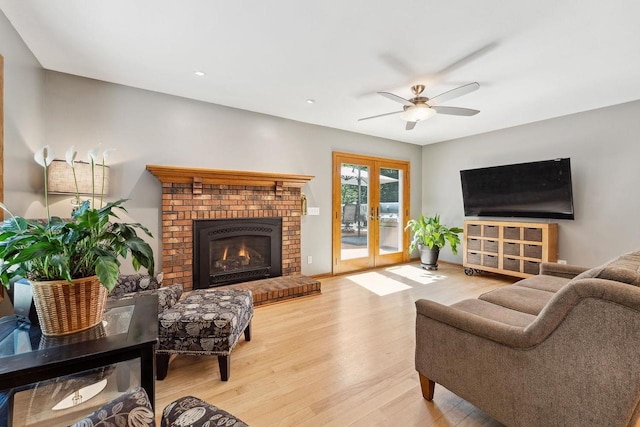 S2916A Fairway Dr, Reedsburg, WI 53959 - living room featuring french doors, a brick fireplace, ceiling fan, and wood-type flooring
