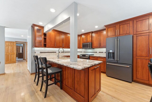S2916A Fairway Dr, Reedsburg, WI 53959 - kitchen featuring light hardwood / wood-style floors, appliances with stainless steel finishes, sink, and light stone counters