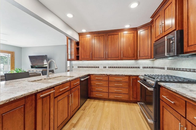 S2916A Fairway Dr, Reedsburg, WI 53959 - kitchen featuring dishwashing machine, sink, light stone counters, and gas range